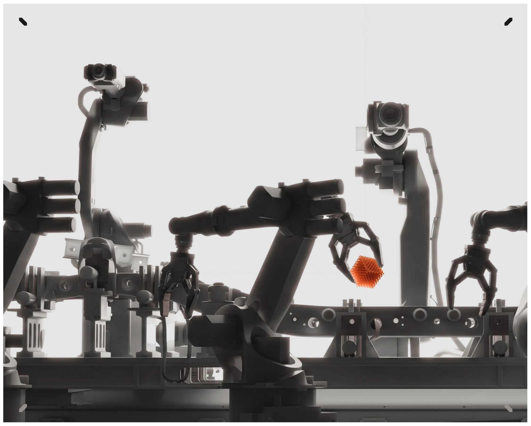 Robot arms on a production line, one holding an orange lattice cube